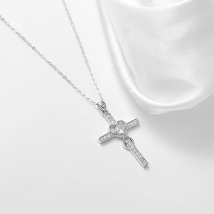S925 sterling silver heart cross necklace with cubic zirconia on white silk background