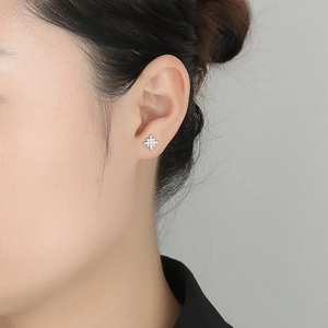 S925 sterling silver star stud earrings with sparkling cubic zirconia on female model