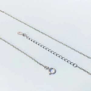 Detailed macro shot of S925 sterling silver water wave chain with hallmark and spring clasp