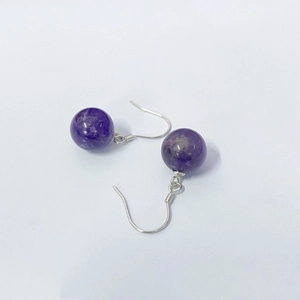 Macro shot of S925 sterling silver hooks with natural purple amethyst round bead earrings