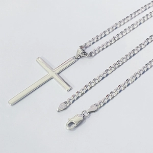Detail view of S925 sterling silver stamp on the lobster clasp of a cross necklace
