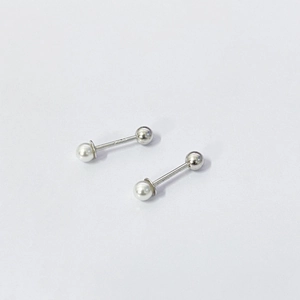 Macro shot of S925 sterling silver pearl screw studs with polished metal back ball