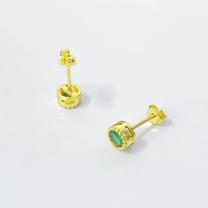 Macro view of gold plated S925 silver stud earrings with a crown-set green zircon stone