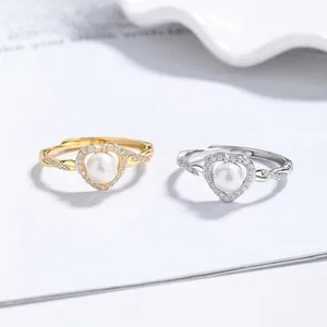 Macro shot of 925 silver heart rings with freshwater pearls and cubic zirconia