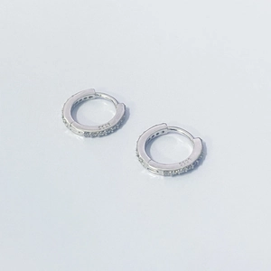 Macro shot showing the S925 hallmark and sparkling zircon inlay on the silver hoop earrings