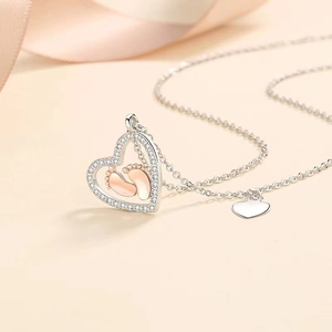 S925 sterling silver heart necklace featuring rose gold baby footprints on champagne silk