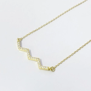 Minimalist S925 silver geometric zigzag necklace with pavé zircon stones on a white background