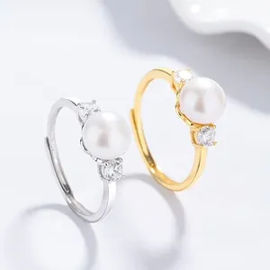 Macro detail of 925 silver fan-shaped rings with freshwater pearls and zircon accents