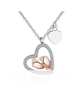 Detailed close-up of S925 silver heart necklace with rose gold baby footprints and diamonds