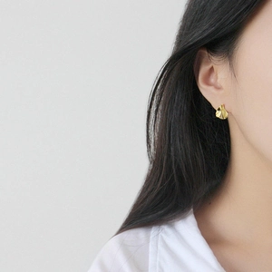 Irregular textured gold S925 sterling silver earrings worn by model for elegant style
