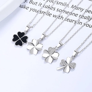 Detail view of four-leaf clover pendant styles in silver, enamel, and pavé diamonds