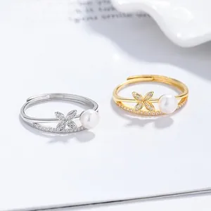 Detail of 925 silver leaf rings with freshwater pearl and zircons in gold and silver