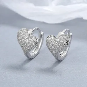 Macro shot of S925 sterling silver heart hoop earrings with micro-pave cubic zirconia