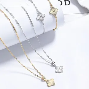 Detail of brushed gold and silver clover pendants on necklaces and bracelets in luxury set