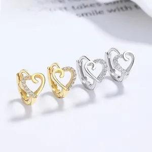 Detail of 925 sterling silver heart earrings with sparkling pavé cubic zirconia setting