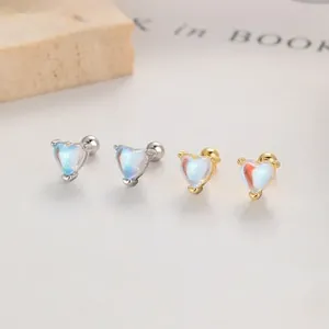Macro view of silver and gold heart stud earrings with iridescent stones and screw backs