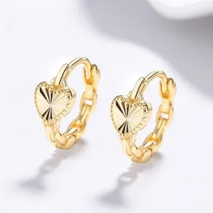 Macro detail of gold-plated 925 silver heart earrings with fine radial texture