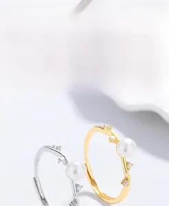 Detail of adjustable S925 silver pearl ring with zircon accents in gold and silver finish