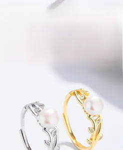 Detail of S925 silver and gold leaf rings with freshwater pearls and zircon accents