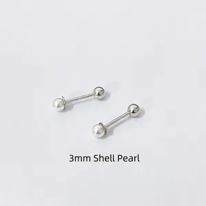 Macro shot of 3mm shell pearl screw back earrings crafted in minimalist sterling silver