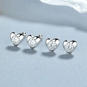 Macro view of 925 silver heart stud earrings with circular cubic zirconia and screw backs