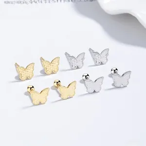 Macro detail of 925 silver butterfly screw-back studs in gold and silver finishes