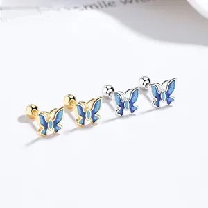 Macro shot of 925 silver butterfly stud earrings with blue enamel and screw back detail