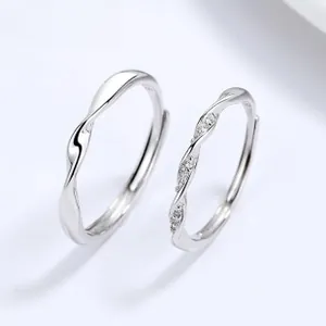 Detail of adjustable S925 sterling silver couple rings with twisted design and stones