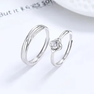 Macro shot of S925 silver couple rings featuring clover design and cubic zirconia