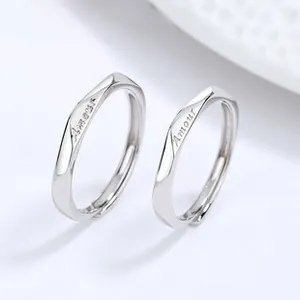 Macro detail of 925 silver couples ring featuring Amour engraving and twisted design