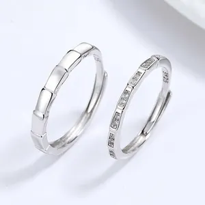 Macro detail of S925 sterling silver couple rings with bamboo joint design and cubic zirconia