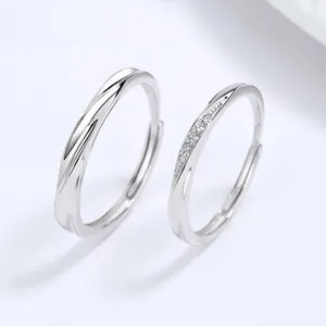Macro shot of silver sterling four-leaf clover couple rings with twisted band and crystals