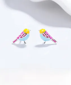Macro shot of colorful enamel bird earrings crafted from polished S925 sterling silver