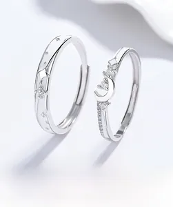 Detail of S925 sterling silver couple rings with moon star design and zircon insets