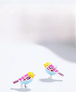 Detailed close-up of S999 sterling silver bird stud earrings with colorful enamel craft