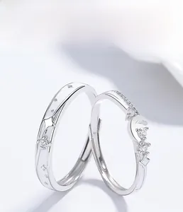 Detailed macro shot of 925 silver couple rings featuring star and crescent moon designs