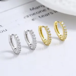 Macro shot of silver and gold S925 sterling silver hoop earrings with white zircon stones