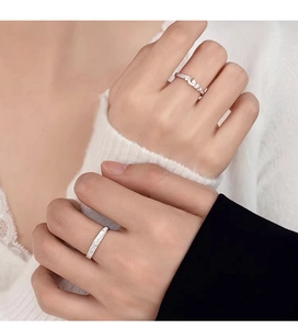 On-hand display of 925 silver couples rings with crescent moon and star patterns
