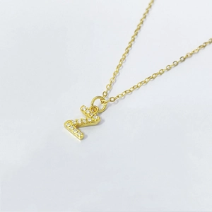 Detailed view of gold Z-letter pendant with pave-set cubic zirconia on a dainty chain