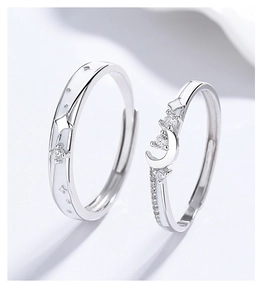 Macro view of 925 silver couple rings with moon and star design and zircon inlays