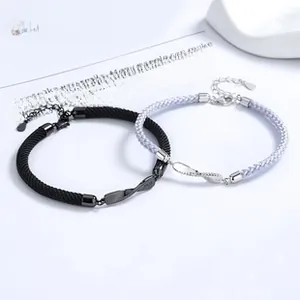 Detail of 925 sterling silver infinity couples bracelets with woven rope and adjustable clasp