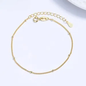 Close-up of double-layer gold S925 silver chain bracelet with lobster clasp and extender