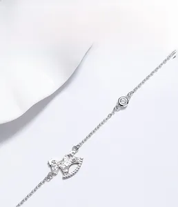 Macro detail of S925 sterling silver rocking horse charm and sparkling zircon on the bracelet