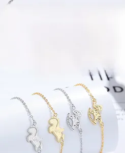 Detailed view of S925 silver rocking horse charms on dainty layered chain bracelets