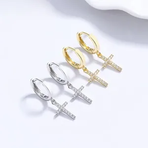 Detailed close-up of 925 silver cross drop earrings in gold and silver finish with zircons