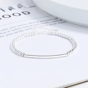 Close-up of 925 sterling silver beaded bracelet with polished tube and adjustable chain