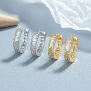 Detail of silver and gold 925 silver hoop earrings with rectangular baguette zircons