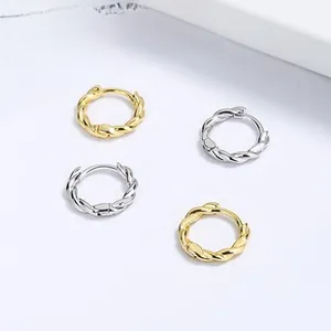 Macro detail of twisted rope hoop earrings in gold and silver finish with secure clasp