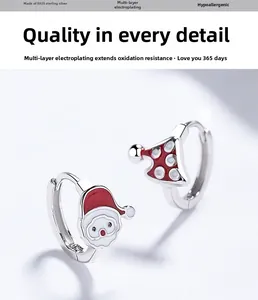 Detail of S925 sterling silver Christmas earrings with enamel Santa and tree charms