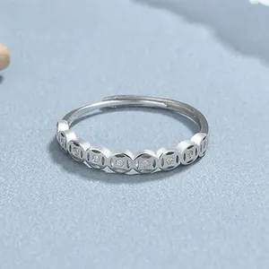 Detailed view of S925 silver coin ring with sparkling cubic zirconia on light blue background